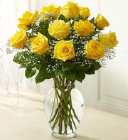 long stem yellow roses in clear vase