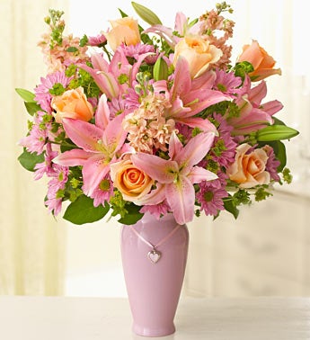 mixed flower arrangement in pink vase